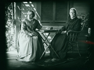 Double portrait of Misses Frances Greely Stevenson and Martha Curtis Stevenson, seated on chairs on a porch, facing front, Manchester, Mass., 1890