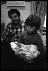 Eben Light holding an infant, Dan Keller in background
