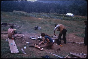 Preparing food in front of the house at Johnson Pasture Commune