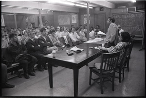 Student Mobilization Committee to End the War in Vietnam meeting against SDS violence: view of audience with chalkboard reading "Amal. Meatcutters welcomes peace movements"