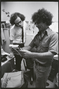 Abbie Hoffman and unidentified man looking at copy of Steal This Book, probably at Harvard Coop