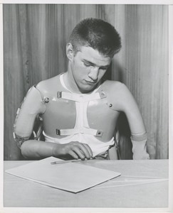 Unidentified man demonstrates arm prosthetics