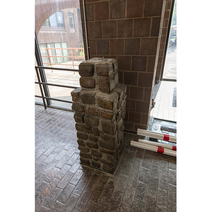 Harriet Tubman House atrium stone pedestal near rear parking lot entrance