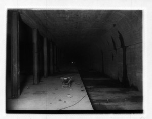 View of interior of Broadway station, showing steel columns and a wheelbarrow