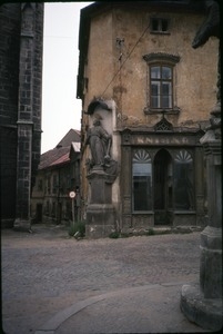 Street, statue, and building corner in cathedral town of Kutná Hora