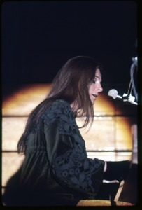 Judy Collins: in green velvet dress playing piano, performing on stage