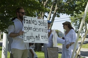 Protester with a sign reading 'Families seeking asylum deserve of empathy, not cruelty': taken at the 'Families Belong Together' protest against the Trump administration’s immigration policies