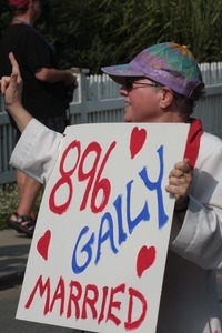 Parade marcher with sign celebrating same sex marriage : Provincetown Carnival parade