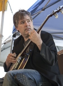 Bela Fleck playing banjo on stage at the Clearwater Festival