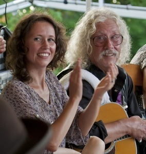 Sarah Lee Guthrie and Arlo Guthrie applauding at the Clearwater Festival