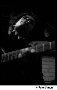 Tim Hardin playing guitar and smoking at the Unicorn Coffee House, Boston, Mass.