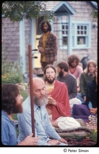 Krishna Das (bottom left) and Ram Dass singing with a group