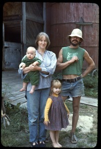 Sandra Marr, Smokey Fuller, and children in front of the barn, Montague Farm Commune