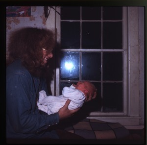 Charles Light holding his infant son (Eben), Montague Farm Commune