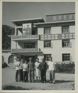Shirley Graham Du Bois with tour guides and residents in front of an unidentified building
