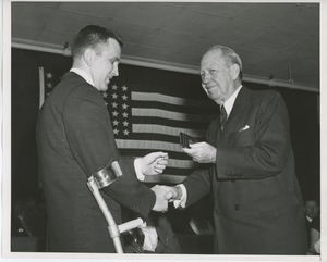 Jeremiah Milbank, Sr. handing gift to client at Institute Day