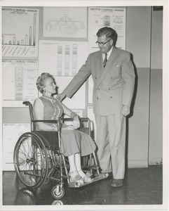 Woman in wheelchair in conversation with a man at an administrators training group