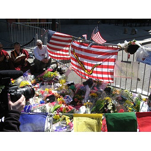 Flags, flowers, and mourners at makeshift memorial for the 2013 Boston Marathon on Boylston Street