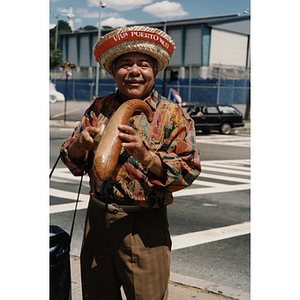 A man plays a gourd instrument during the Festival Puertorriqueño parade