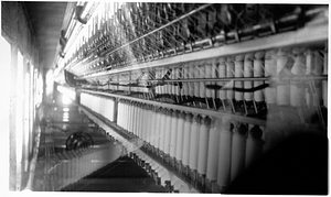 Spinning frame in the spinning room of a textile mill. [02]