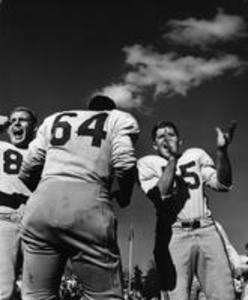 Football players cheering, 1958