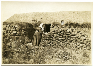 A crofter piling peat on the Isle of Skye in Scotland