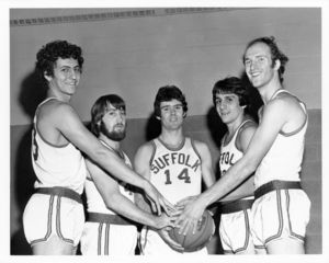 Suffolk University men's basketball players holding a basketball, 1975