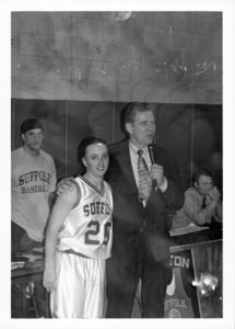 Suffolk University women's basketball player Kate Norton with Athletics Director James E. Nelson at an award presentation, circa 1999