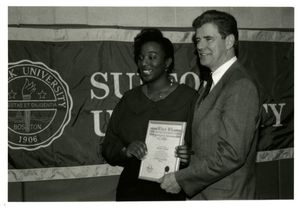 Athletics Director James E. Nelson presents Who's Who award to student Melissa De Lay at Suffolk University's 1994 Recognition Day