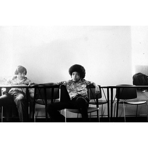 Two male Hispanic American teenagers seated in a classroom at La Alianza Hispana headquarters, Roxbury, Mass.