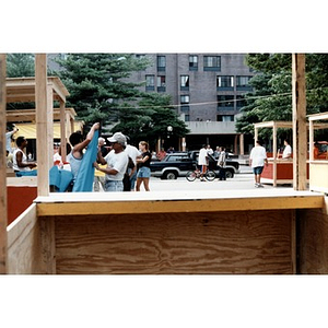 People prepare the plywood concession stands that have been built for Festival Betances.