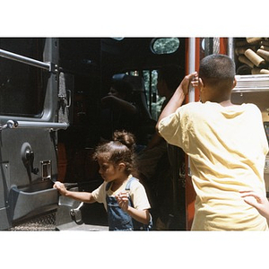 Children exploring a fire truck at Festival Betances.