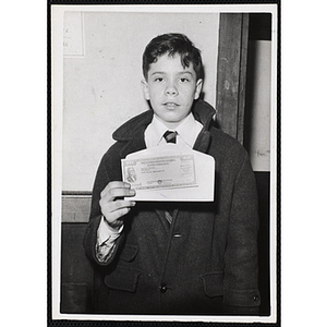 Larry Perkins from the Boys' Clubs of Boston posing with a fifty-dollar bill