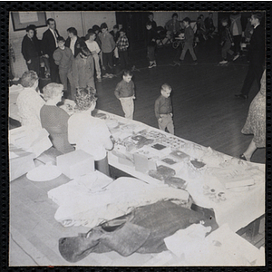 Boys walk near a table of baked goods during a Cake Walk sponsored the Women's Club