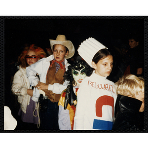 Children in Halloween costumes stand in line