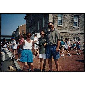 A girl poses with two adults at the Battle of Bunker Hill Road Race