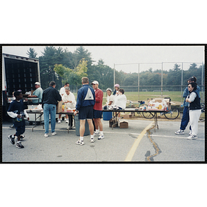 Children and adults gather at the craft table during The Partnership Ride