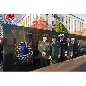 Vice Admiral Mark Fitzgerald and four others stand next to the Veterans Memorial at the dedication ceremony