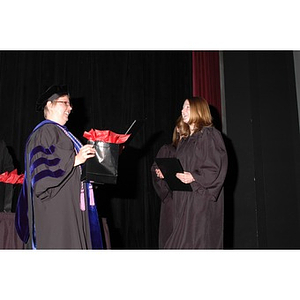 Faculty member presents students with gift bags at School of Nursing convocation