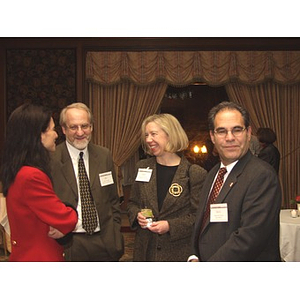 Four people talking at the gala dinner to honor John Hatsopoulos