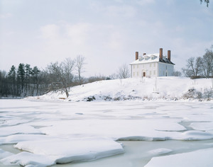 Exterior in snow from across the frozen river, Hamilton House, South Berwick, Maine