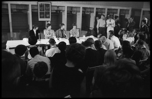 Ringo Starr, Paul McCartney, John Lennon, and George Harrison (l. to r.) seated at a table during a Beatles press conference