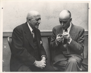 W. E. B. Du Bois seated with unidentified man smoking a pipe
