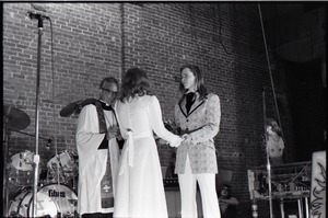 Wedding of Jim and Anne Baker: exchanging vows in front of minister and drum set