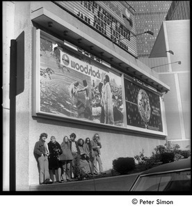 Group beneath the Woodstock movie billboard, Cheri theater