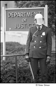 Member of the Civil Disturbance Unit in front of the Department of Justice