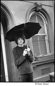 Peter Simon holding an umbrella