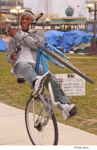Occupy Baltimore: young man doing tricks on a bicycle