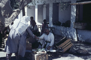 Woman pays a street vendor