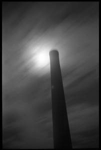 Smokestack of power plant against a full moon, UMass Amherst